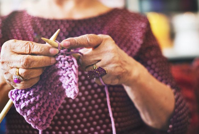 Image of a person knitting.