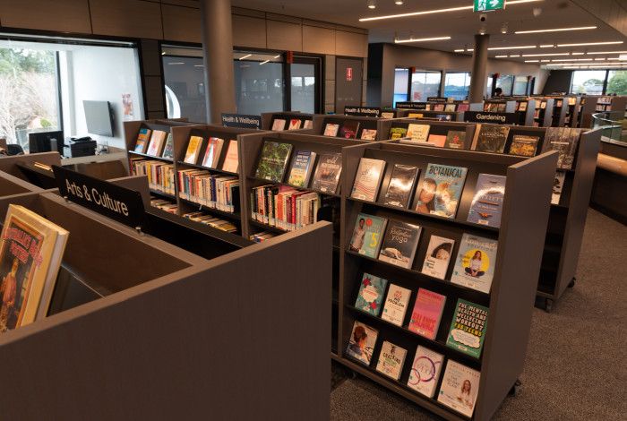 Image: bookshelves in a library.