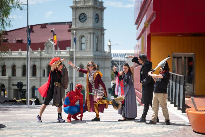 Library staff dressed in costumes such as superheroes and pirates.