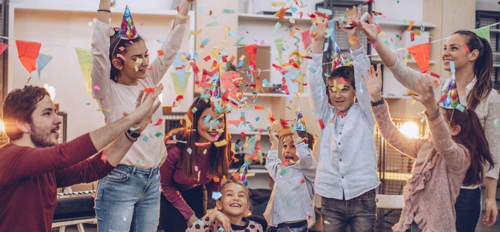 People celebrating and throwing confetti in the air.