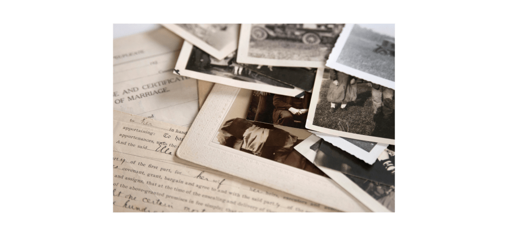 Old family photos in black and white and a marriage certificate.