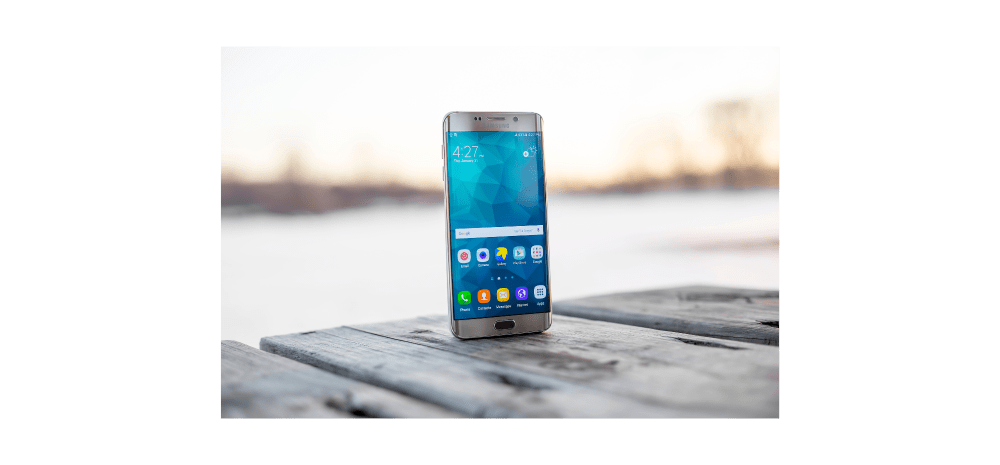 A phone on an outdoor table.