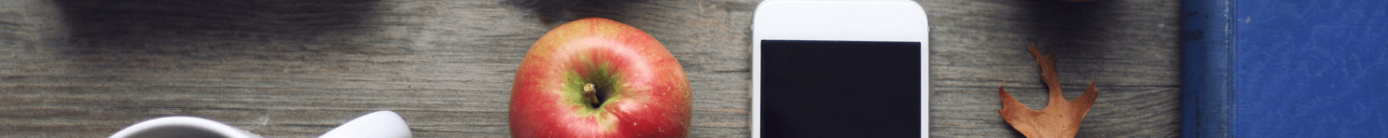 A tray with some apples and an iphone