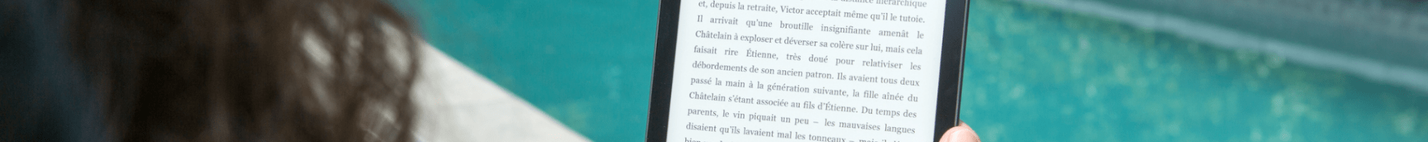 A woman reading an ebook by a pool on a device