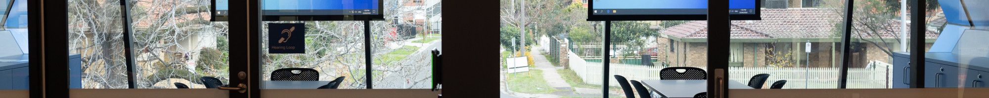 Image: View of a meeting room in the library with desks and screens