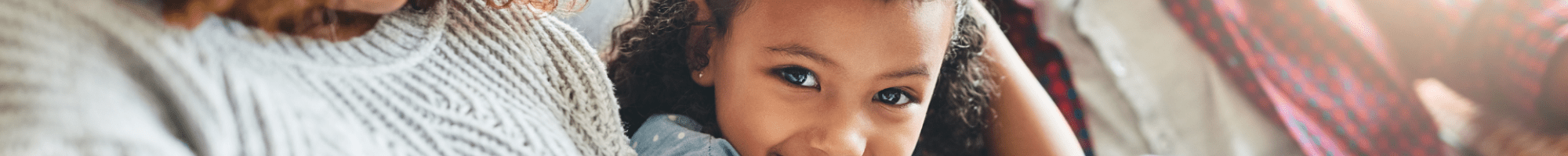 Man and a woman looking at a laptop with a child