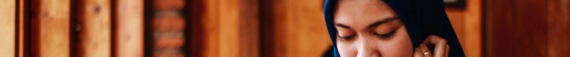 Image: A woman reading at a table