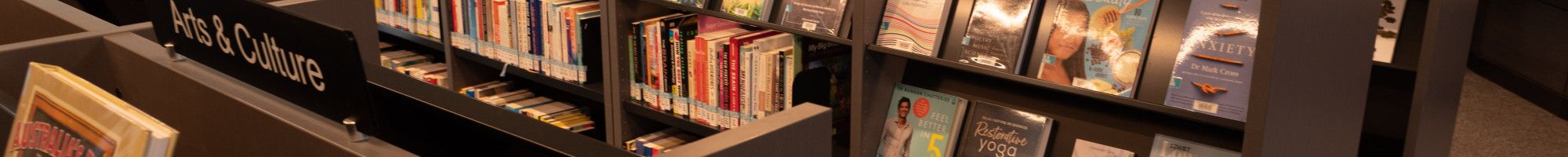 Image: bookshelves in a library.