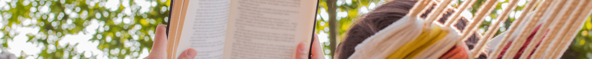 Woman in a hammock reading a book