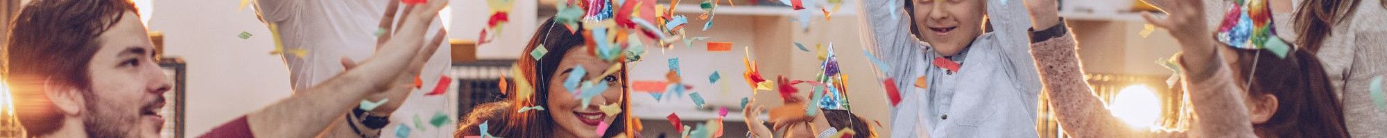 People celebrating and throwing confetti in the air.