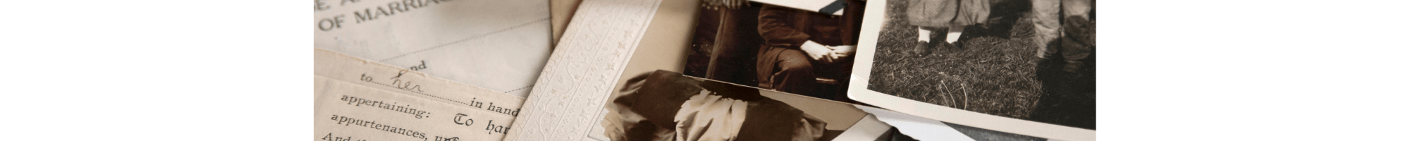 Old family photos in black and white and a marriage certificate.