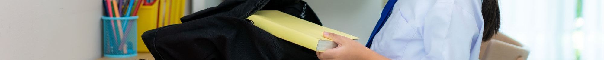 A girl packing her books for school