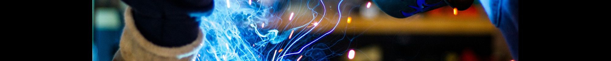 Figure in protecting clothing welding or electroplating.