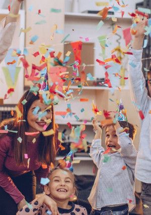 People celebrating and throwing confetti in the air.