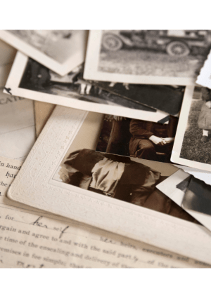 Old family photos in black and white and a marriage certificate.