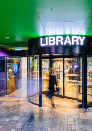 Front door of Dandenong Library. The word Library appears above the door.