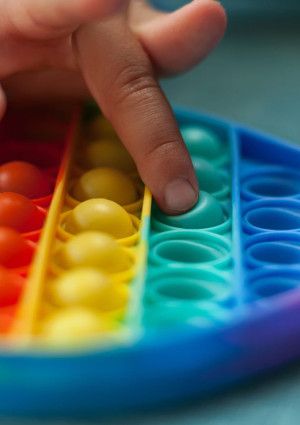 Heart shaped rainbow coloured sensory toy.